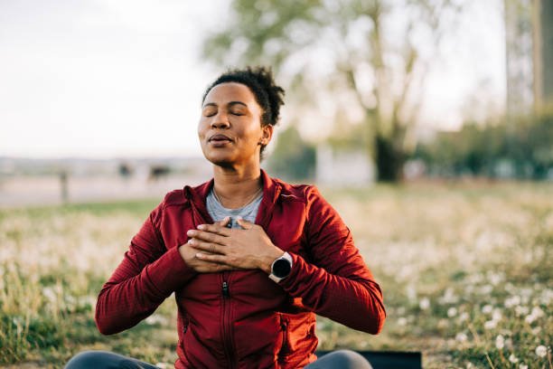 Person standing peacefully by the water, embracing personal growth and well-being